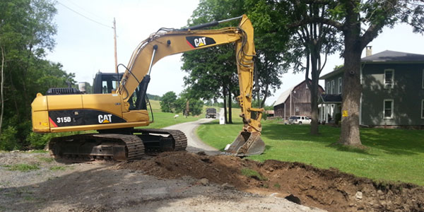 A backhoe digging up some dirt holes in the ground